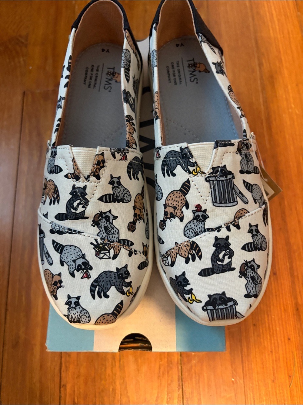Toms Kids White Canvas Slip-On Shoes with Black and Brown Raccoon Print